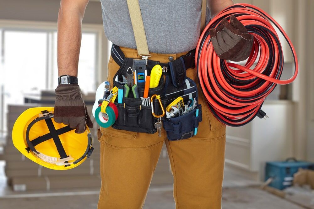 An Electrician Holding Tools and Wires — Electrical Solutions in Coolum Beach, QLD