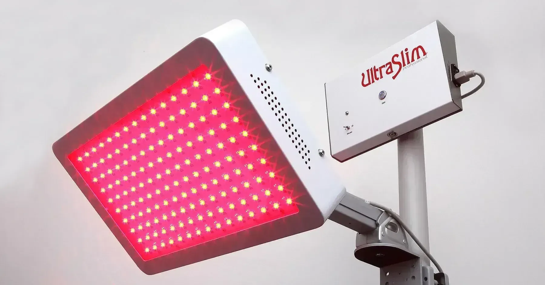 Red light therapy device, white with red LEDs, mounted on a stand.