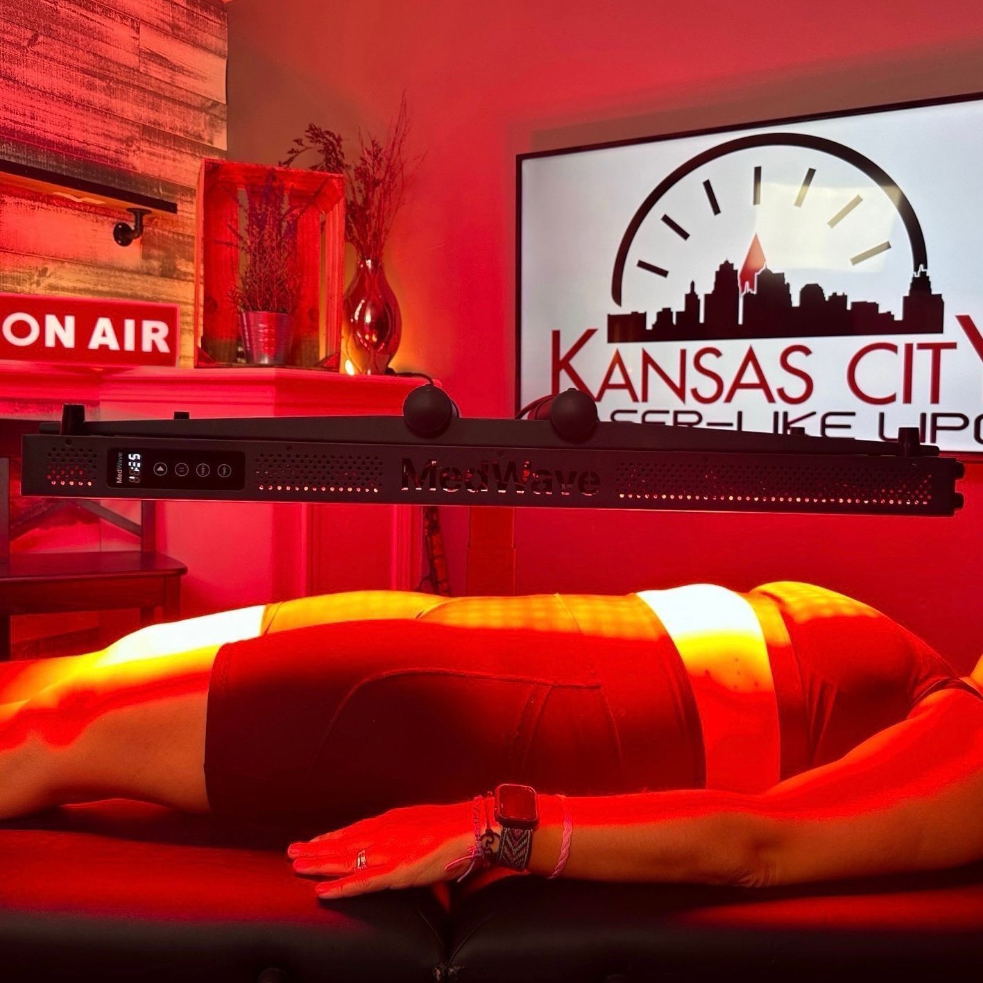 Person receiving red light therapy treatment in a room with a 