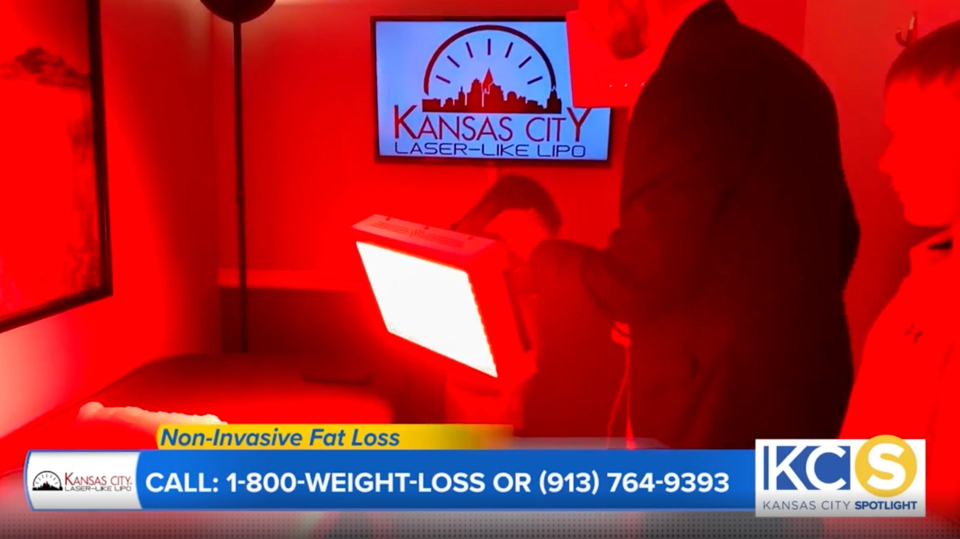 A red-lit room with a person holding a device. A TV shows 