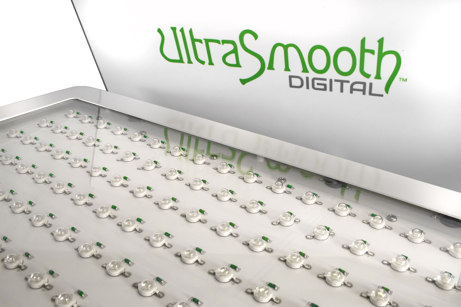 Close-up of a white panel with numerous small, evenly spaced LED lights; 