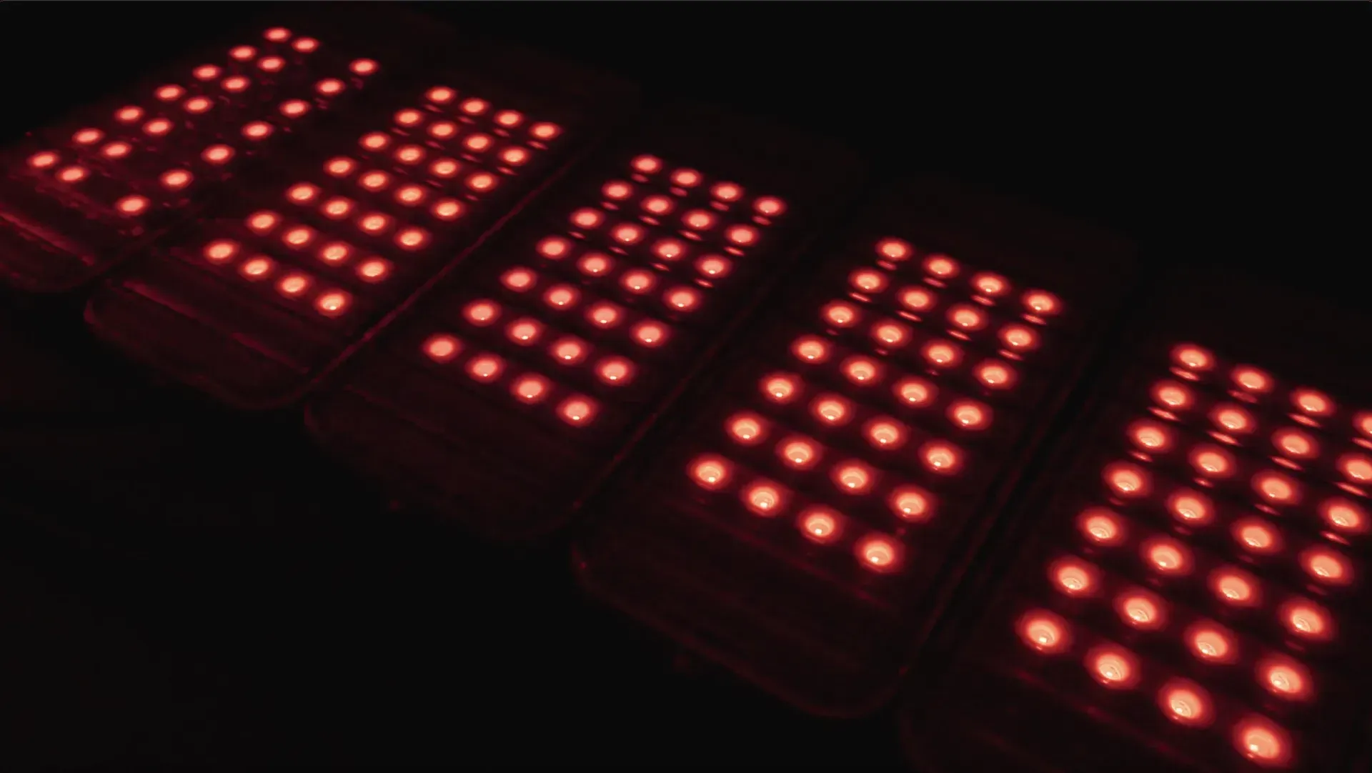 Five rectangular panels with many bright red LED lights.