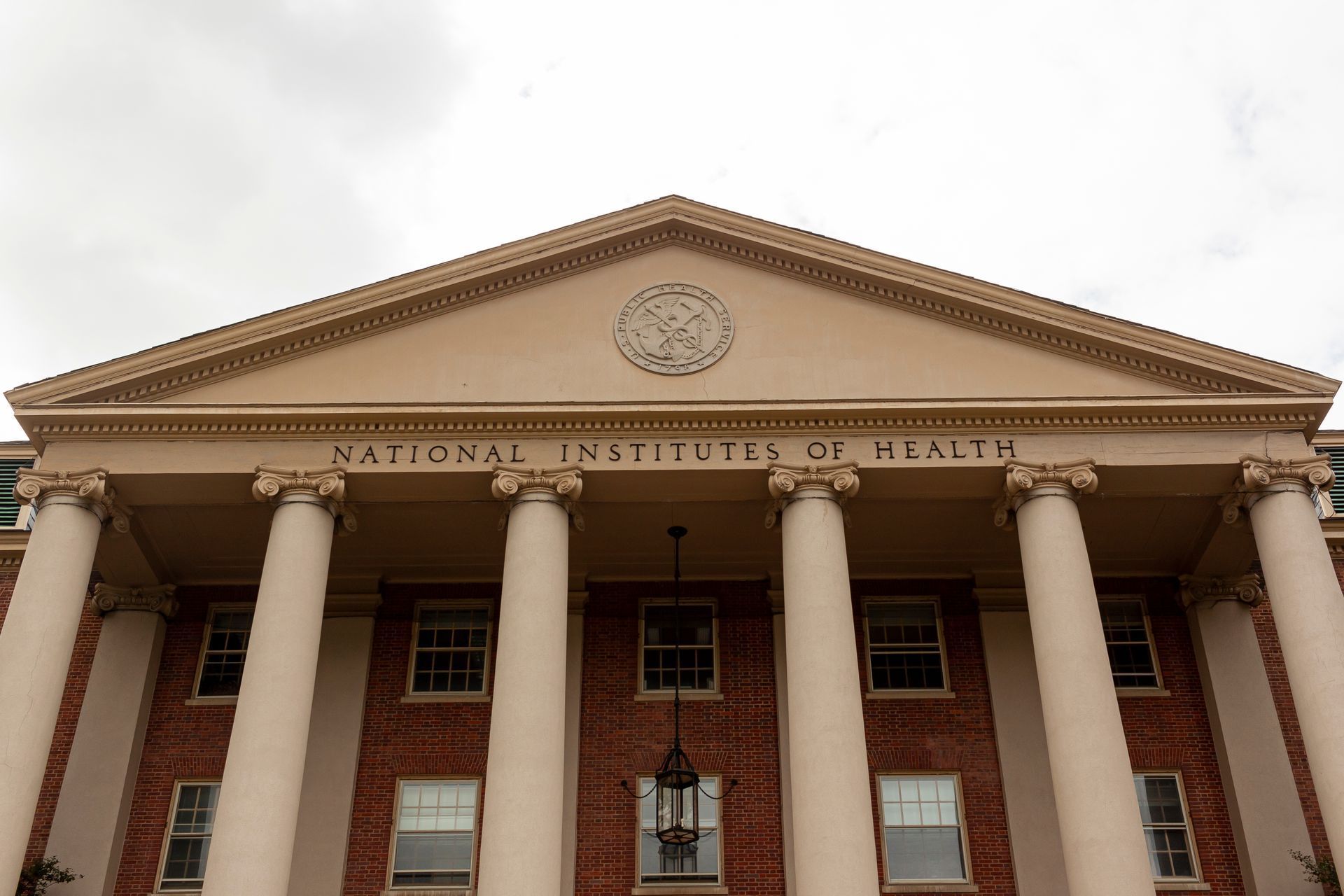 National Institutes of Health building with columns, brick facade, and text 