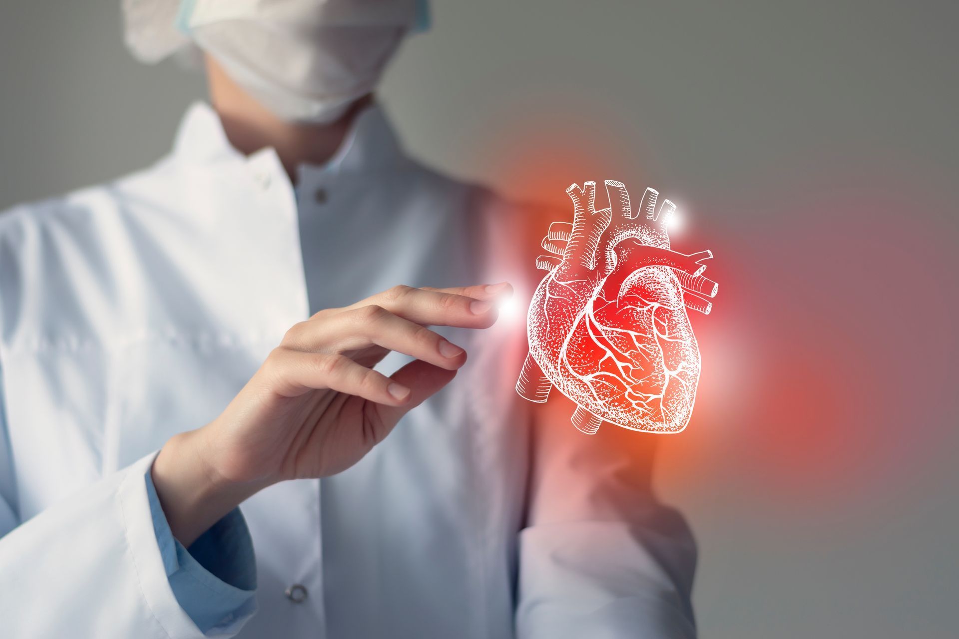 Doctor in lab coat interacts with glowing, digital heart illustration.