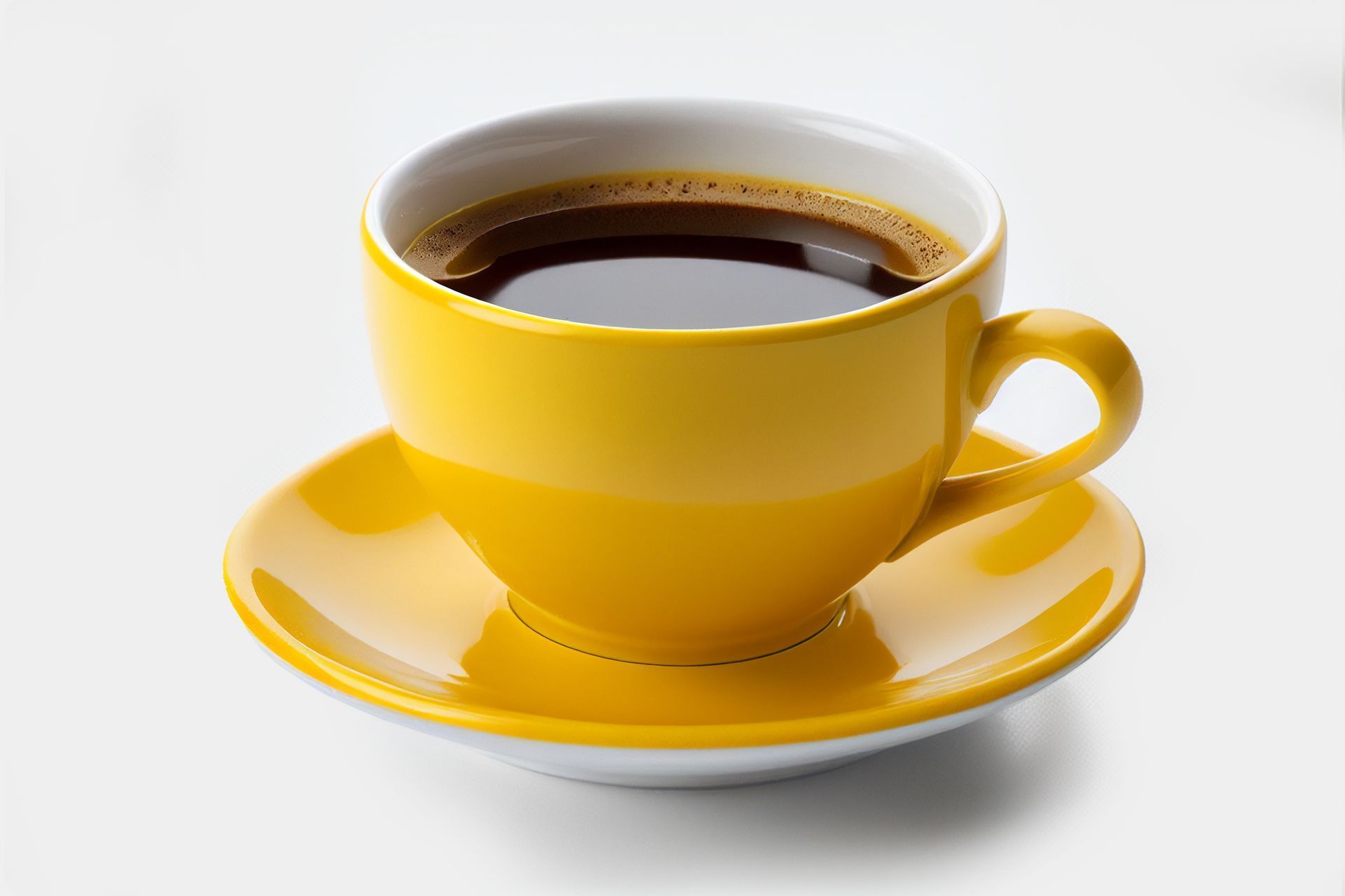 Yellow coffee cup filled with dark coffee, sitting on a matching saucer.
