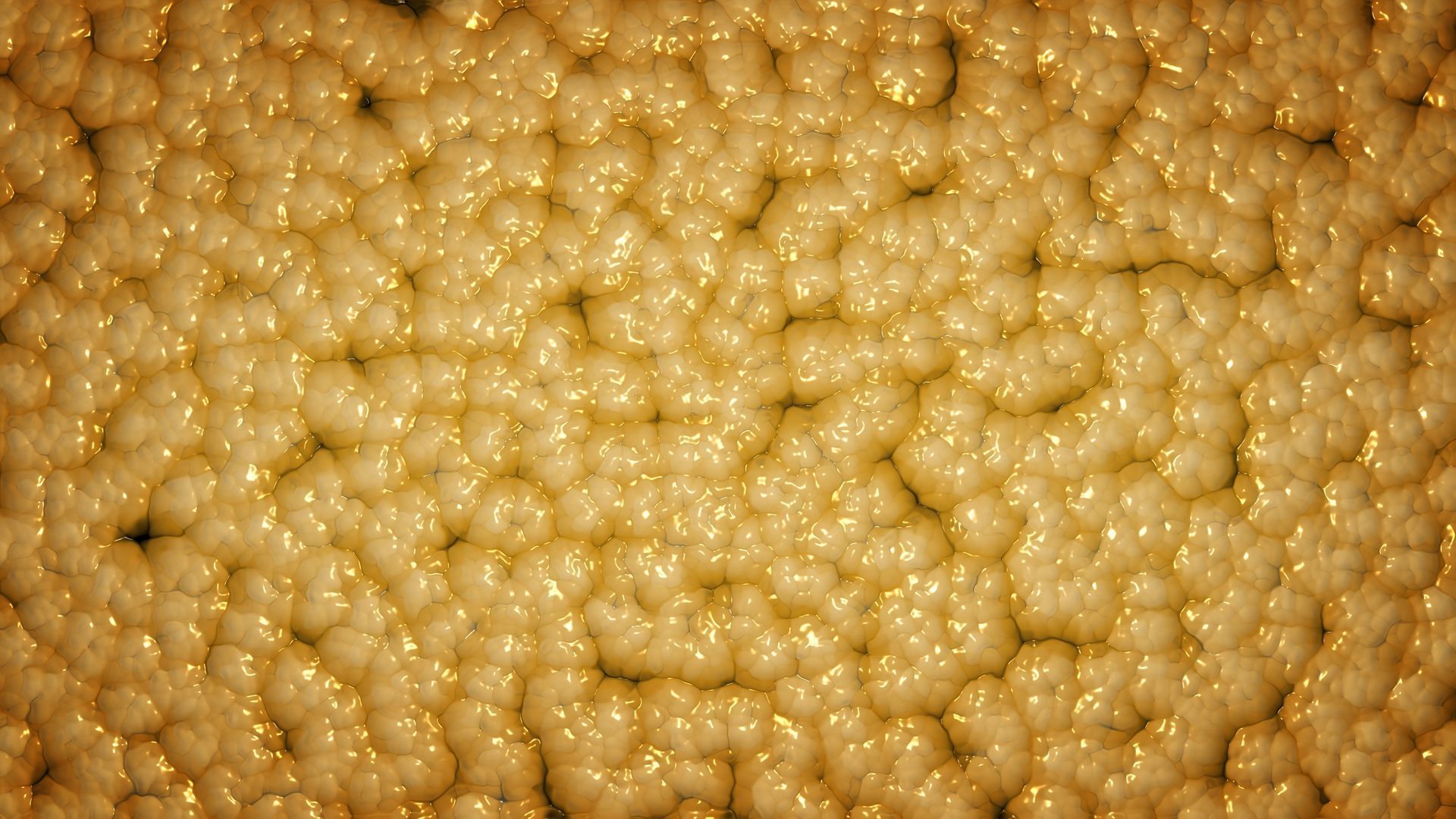 Close-up of a bumpy, golden-yellow surface with highlights and shadows, resembling organic material.