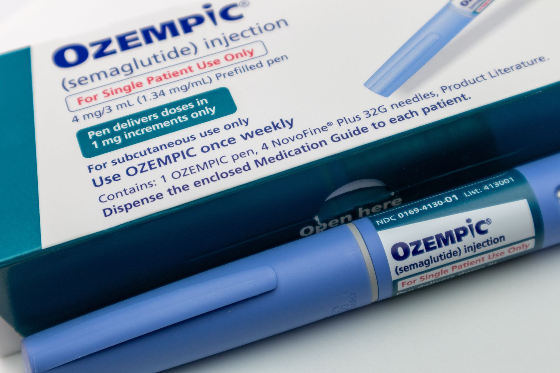 Ozempic medication box and pen-like injection device, light blue and white colors, for single patient use.