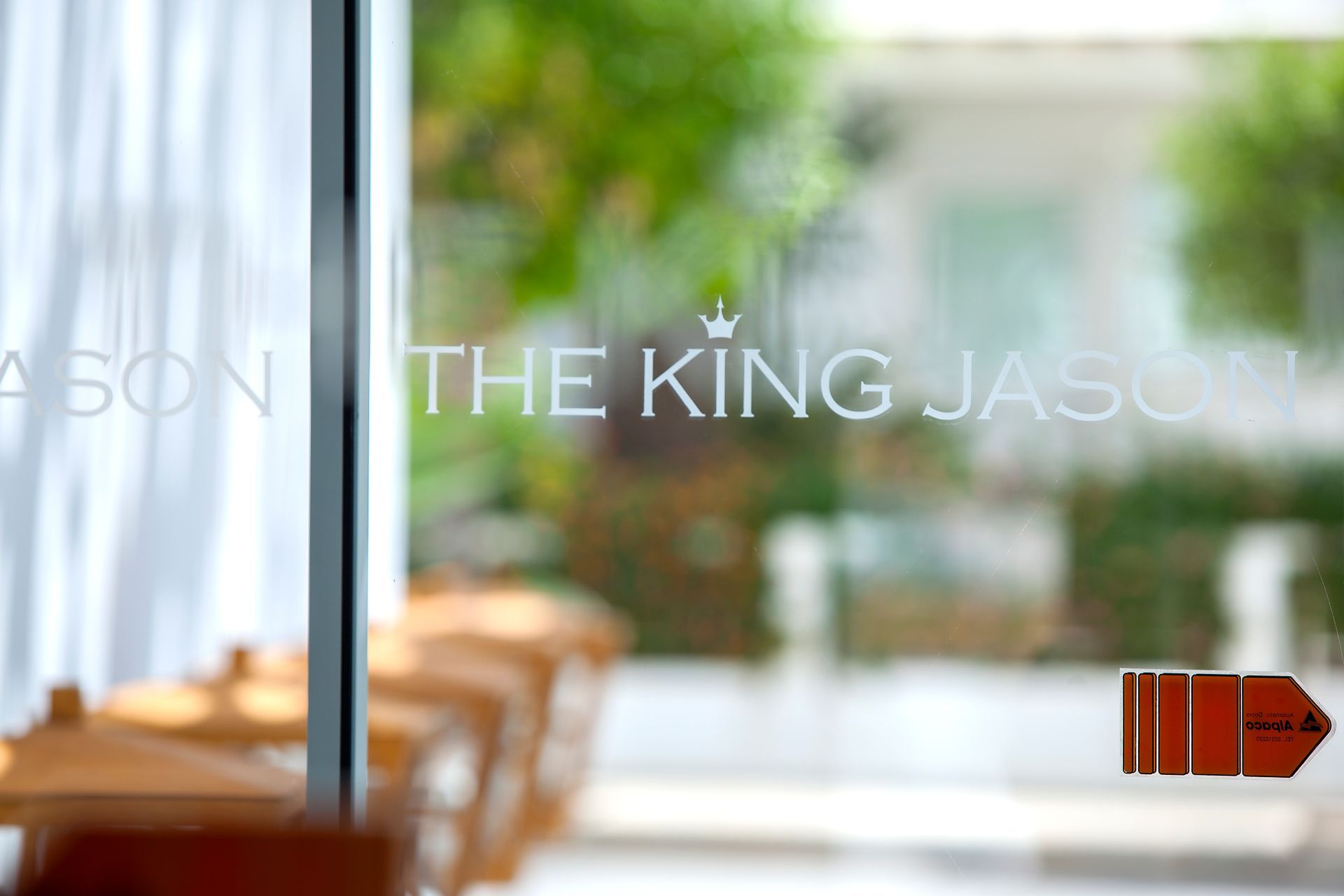 Glass door of The King Jason hotel with.
