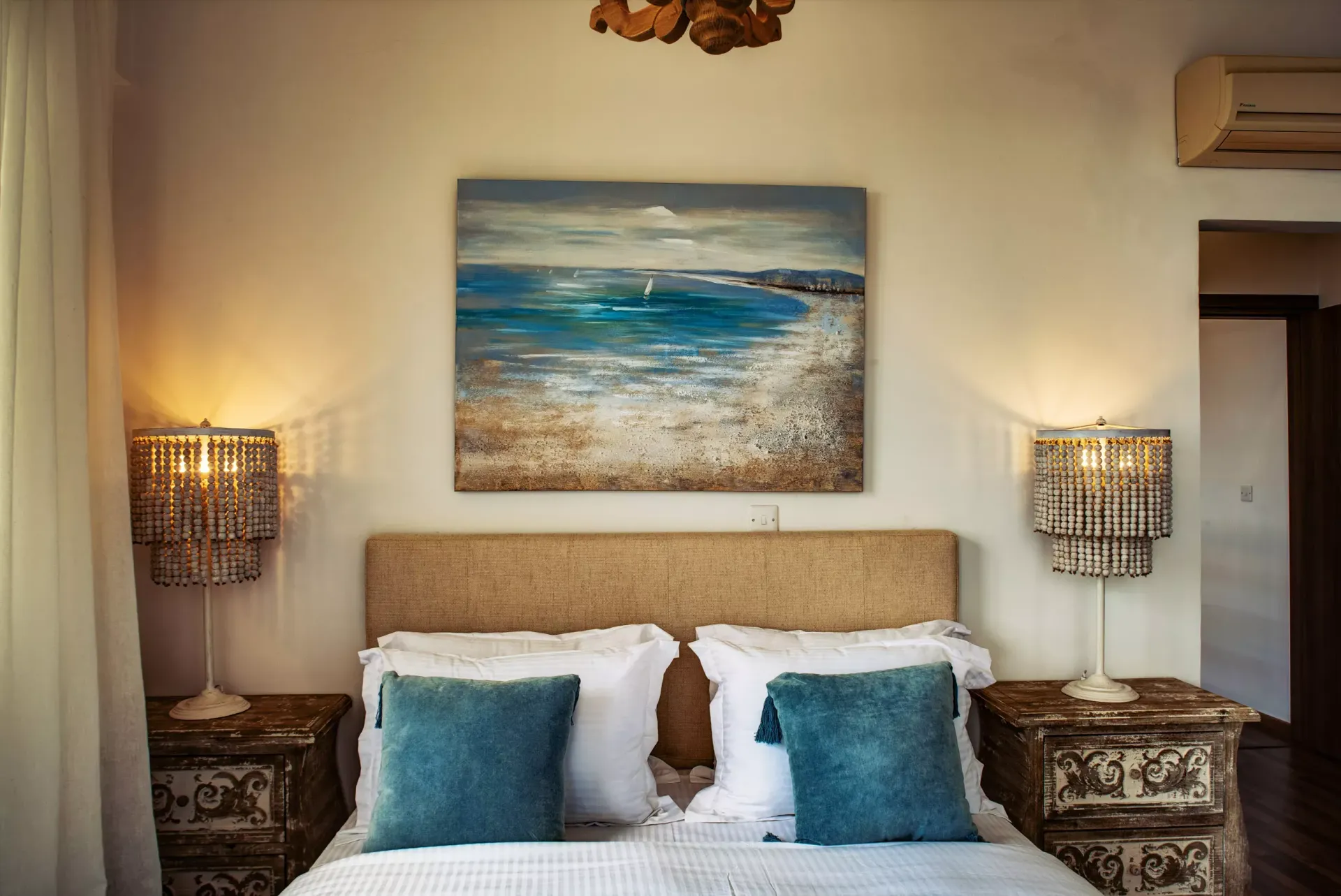 There is a painting on the wall above the bed in the bedroom.