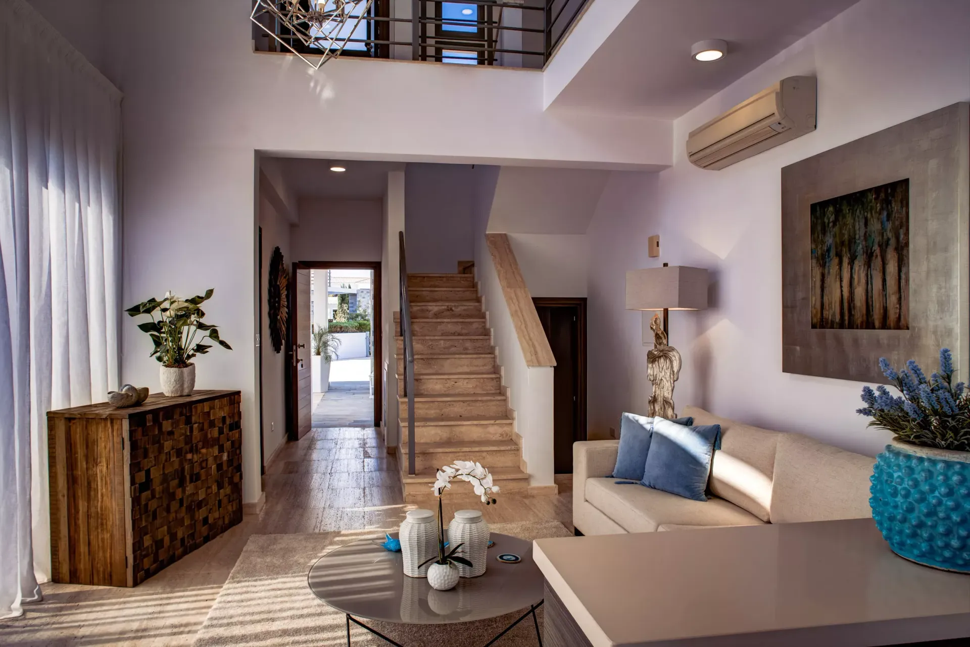 A living room with a couch , table , and stairs.