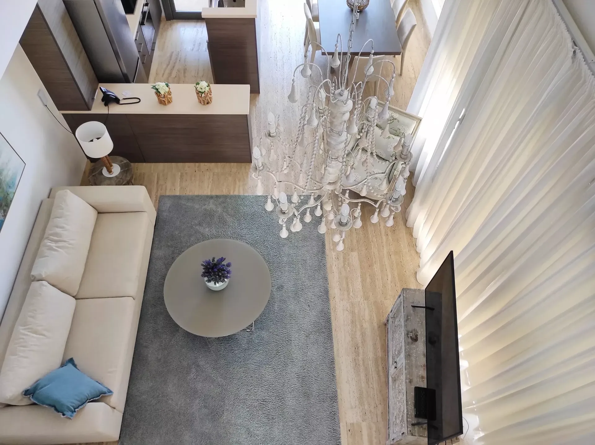 An aerial view of a living room with a couch and a chandelier