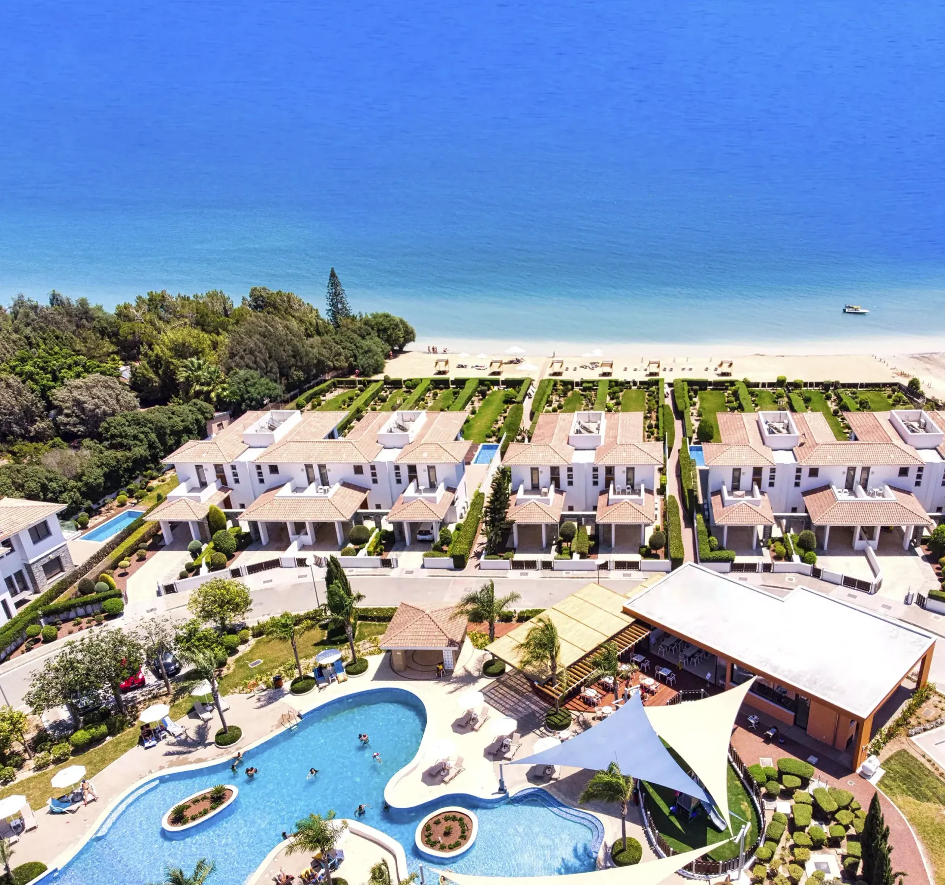 An aerial view of a resort with a large swimming pool