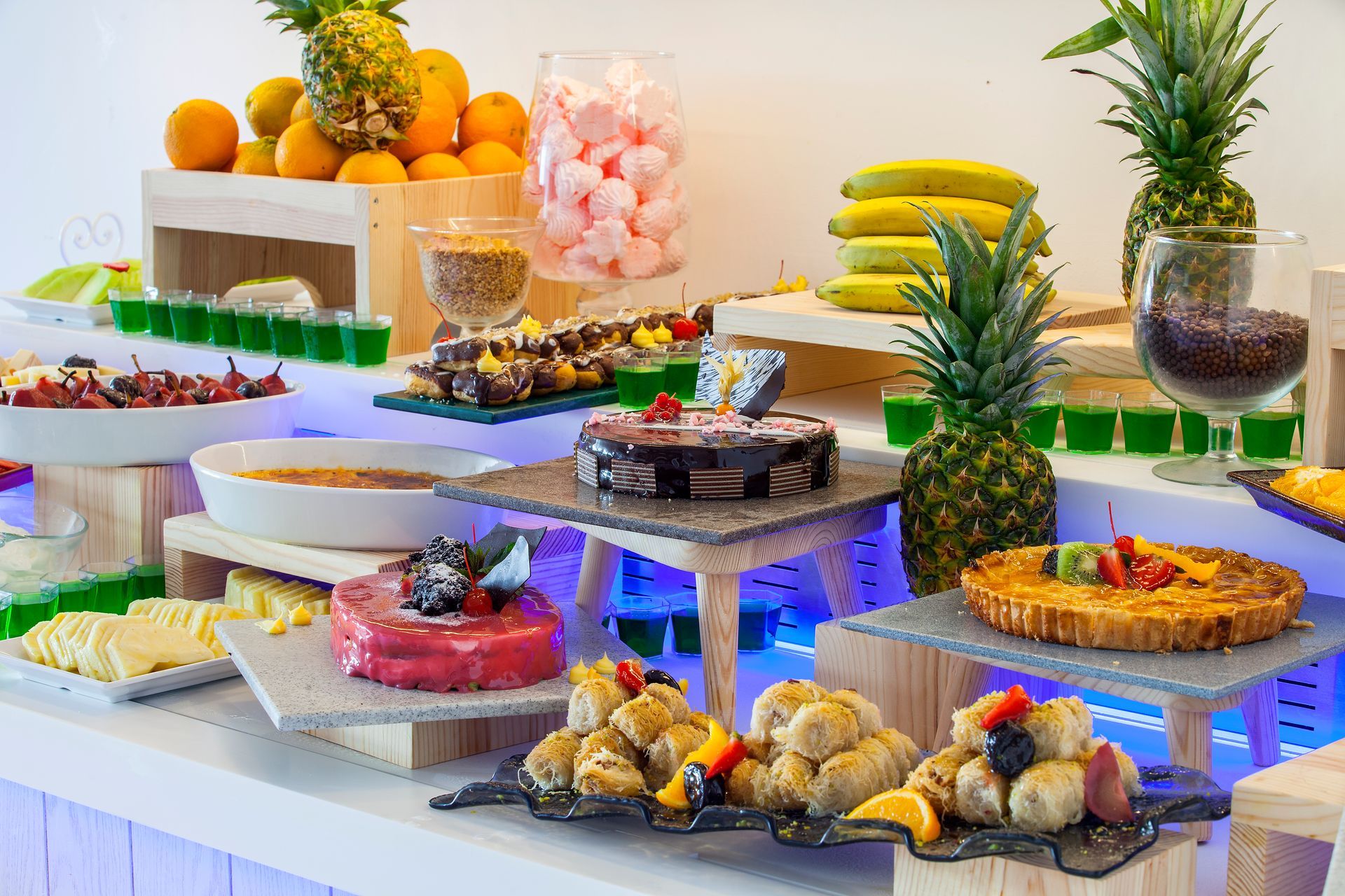 Buffet table with various desserts, fruits, and drinks, all-inclusive at King Jason Protaras.