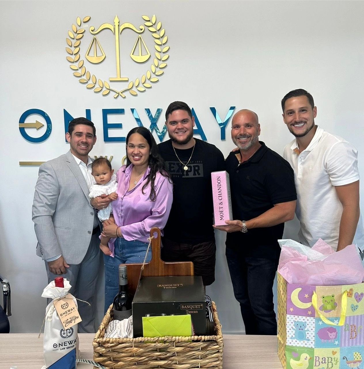 A group of people standing in front of a wall that says one way