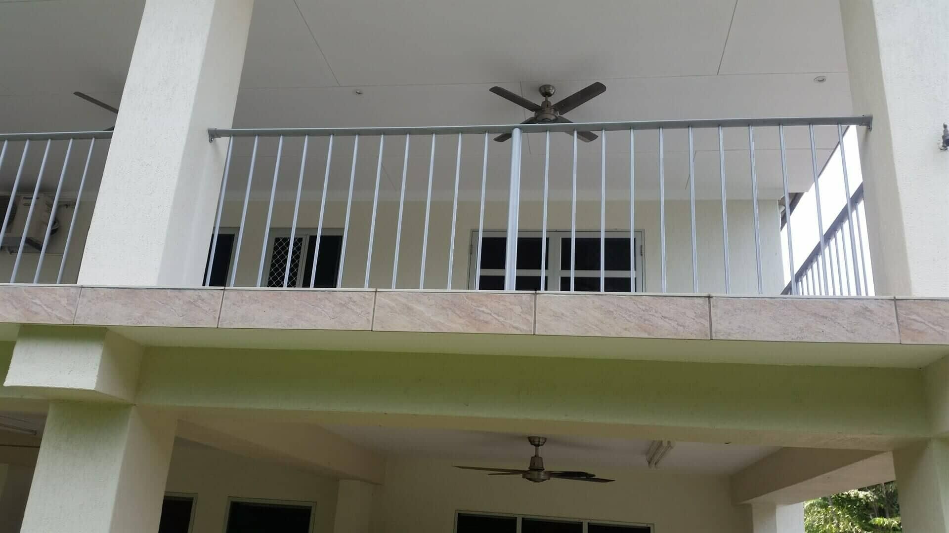 A Balcony With A Metal Railing And A Ceiling Fan — Rabbo's Fencing Services In Pinelands, NT