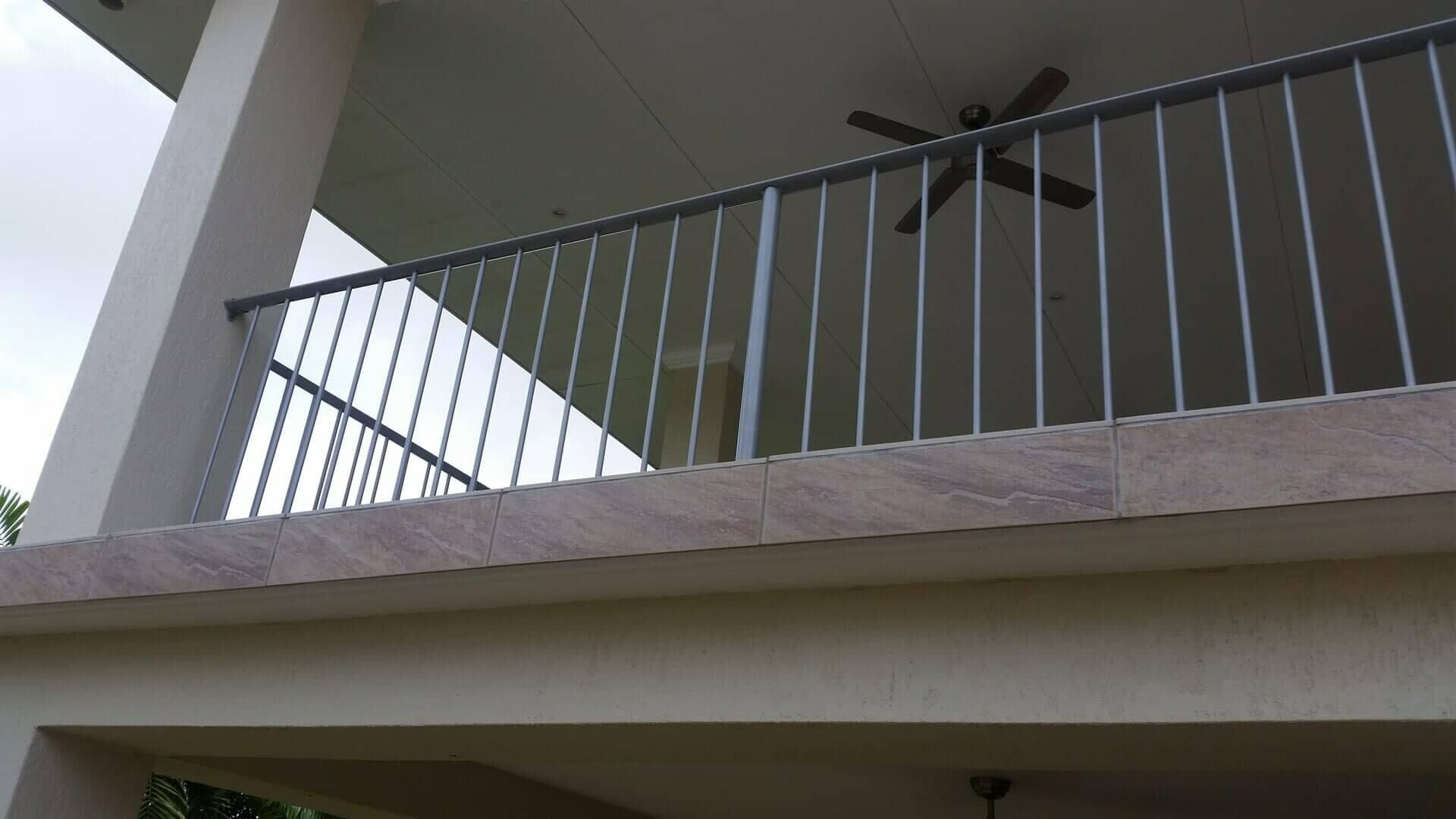 A Balcony With A Metal Railing And A Ceiling Fan — Rabbo's Fencing Services In Pinelands, NT