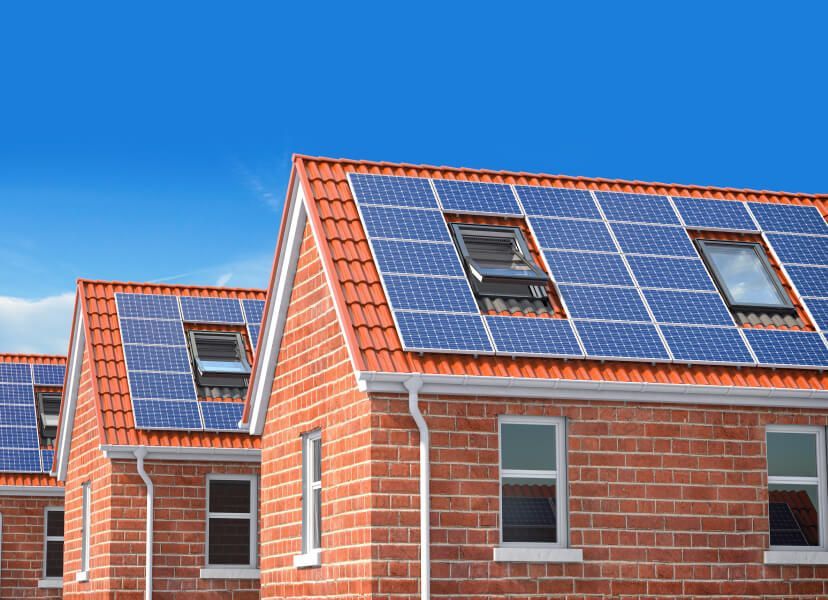 A row of brick houses with solar panels on the roofs