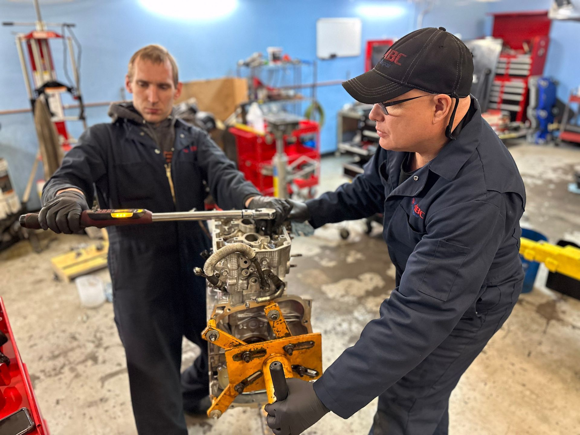 ABC Auto Repair master technician in Burien torquing engine cylinder head during repair