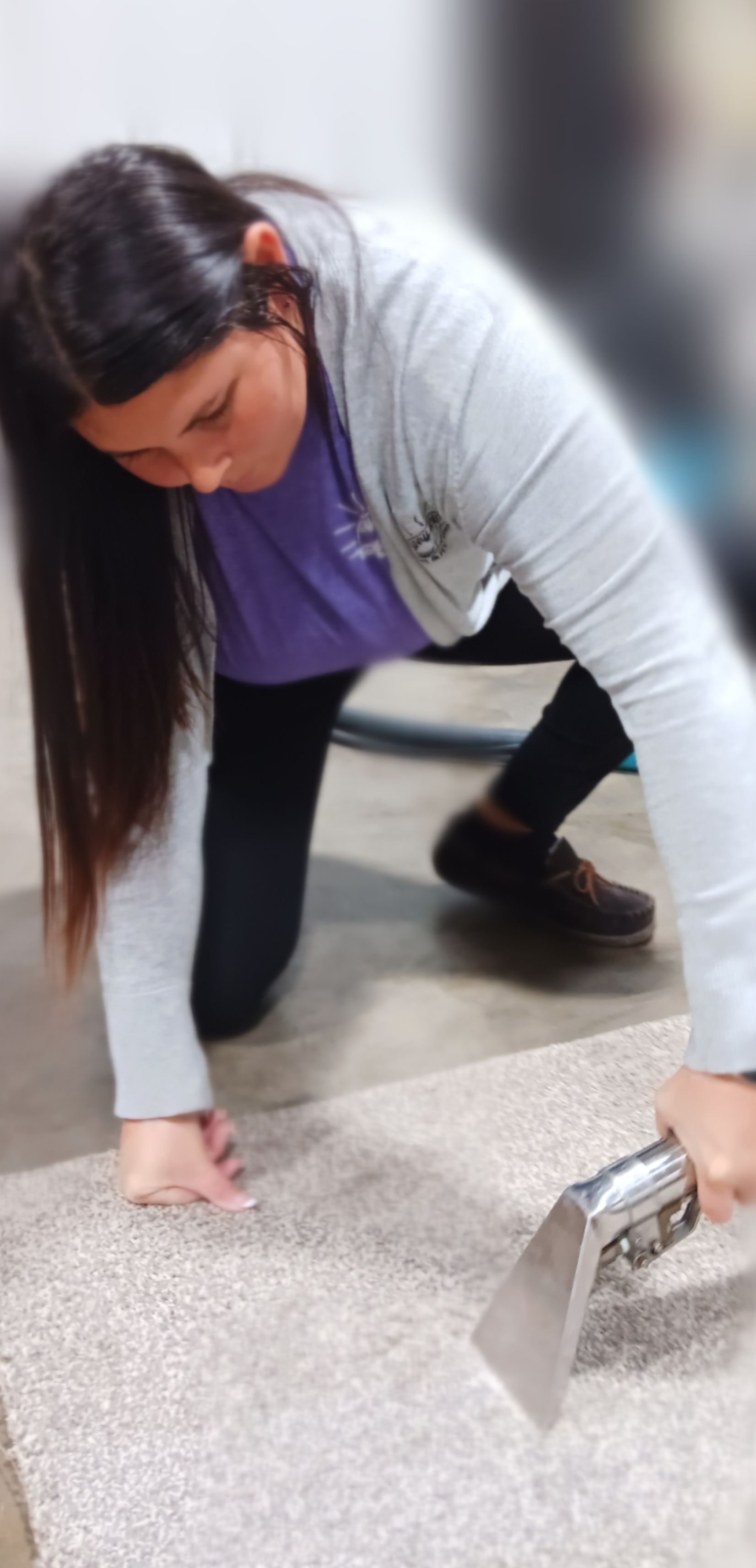 A living room with a couch , chairs , and lots of windows.