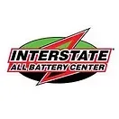 A boat on a trailer is parked in front of a building.