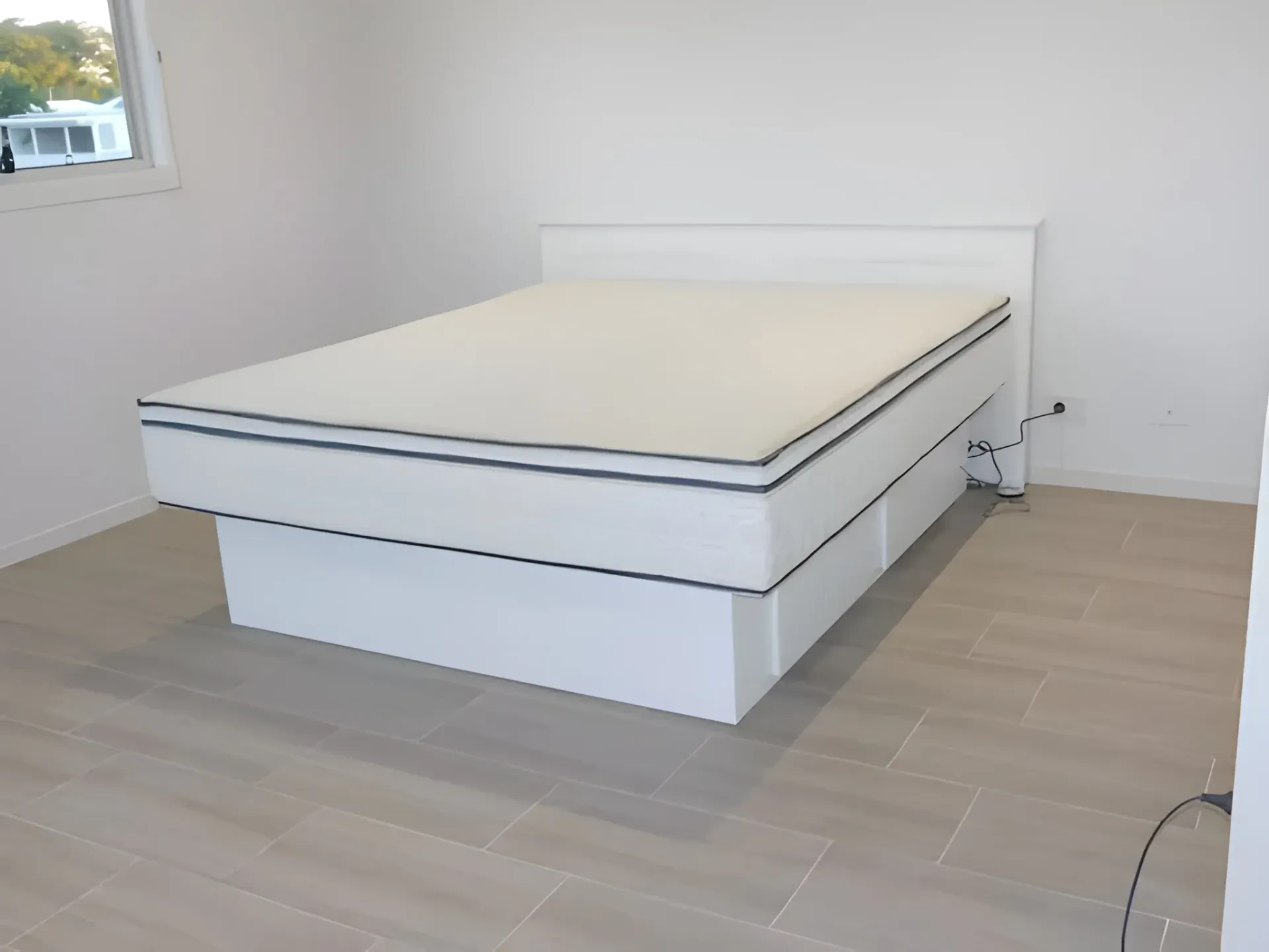 A Bed Frame with Mattress in A Bright Room — Water Works Waterbeds in Chermside, QLD