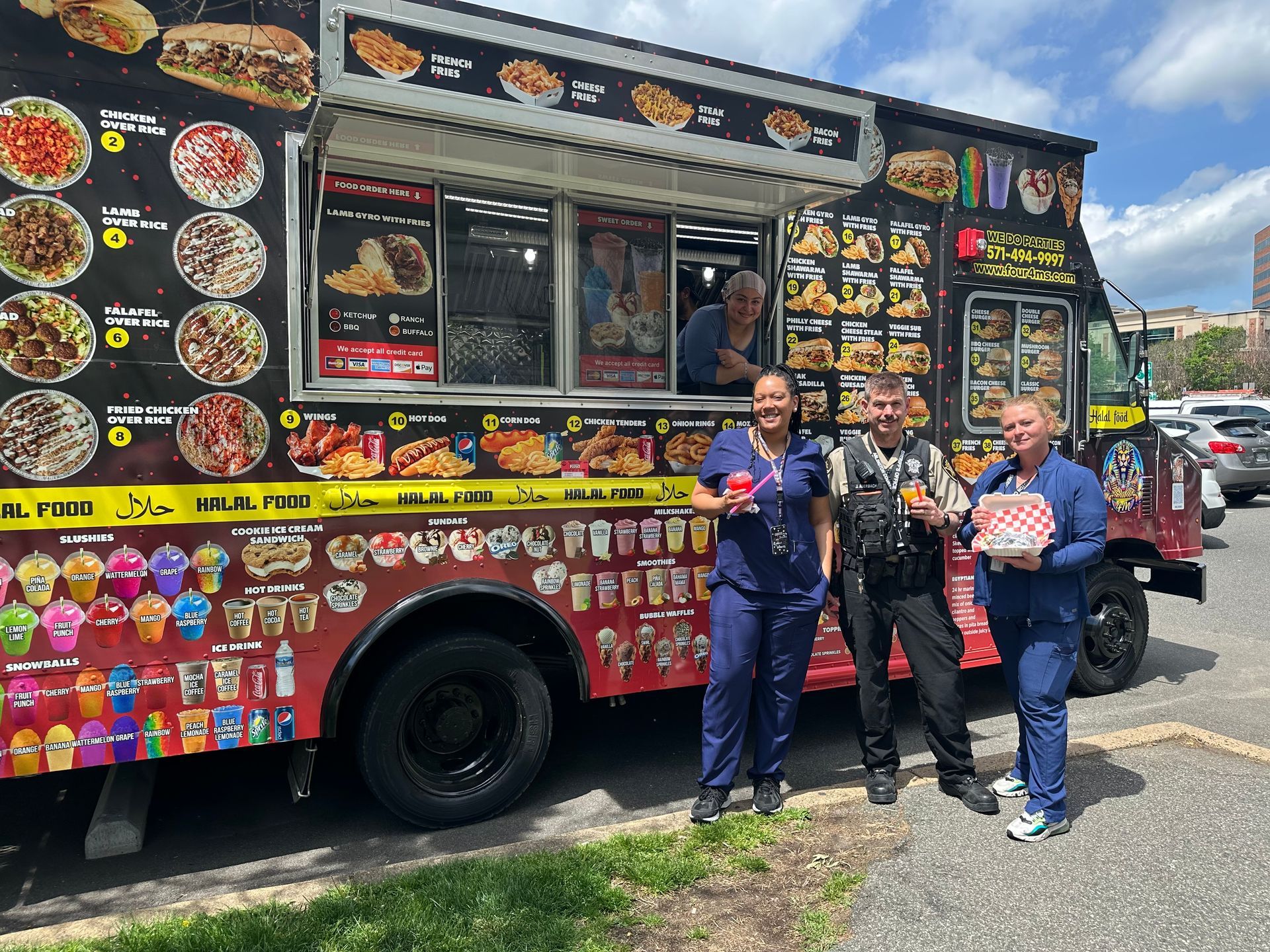 A group of people standing in front of a food truck.