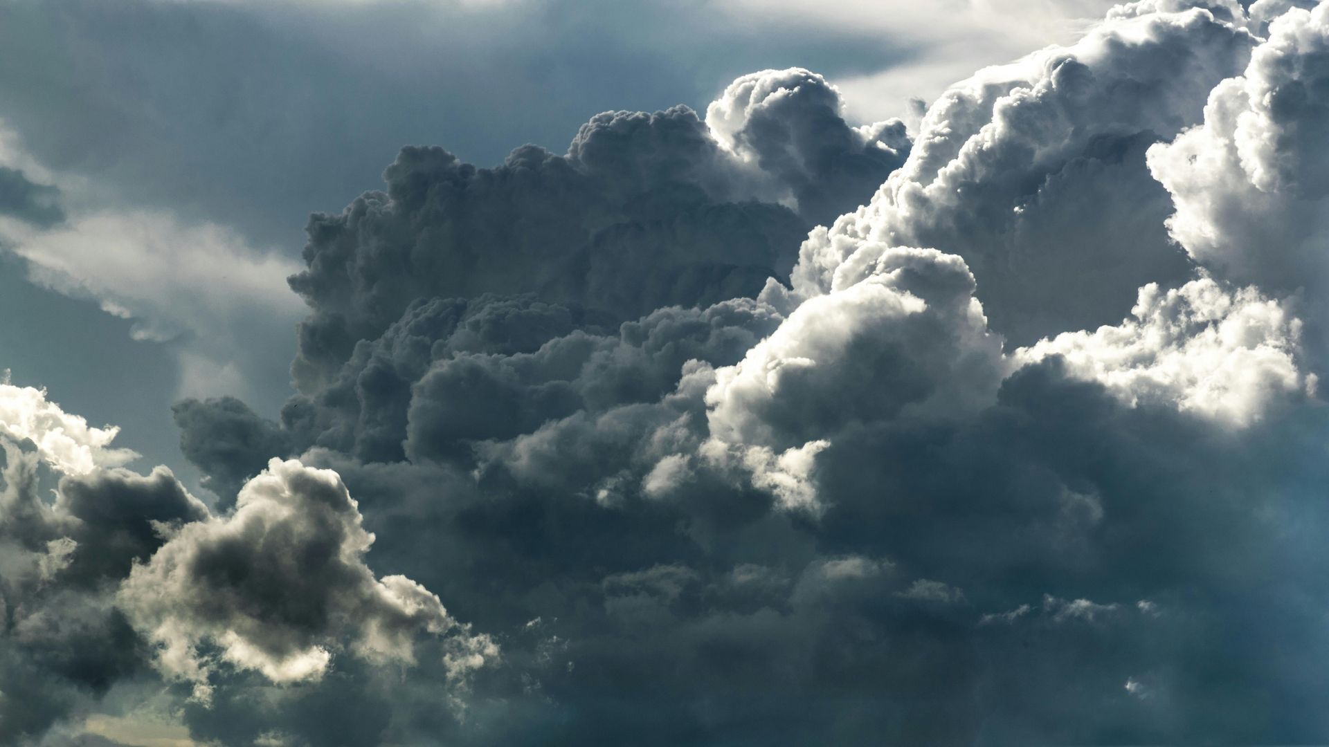 A cloudy sky with the sun shining through the clouds