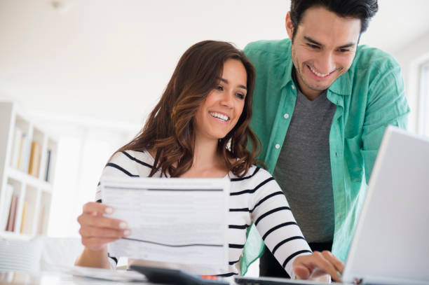A man and a woman are looking at a laptop computer - University Heights, OH - Ralph P. Sills Insurance Agency