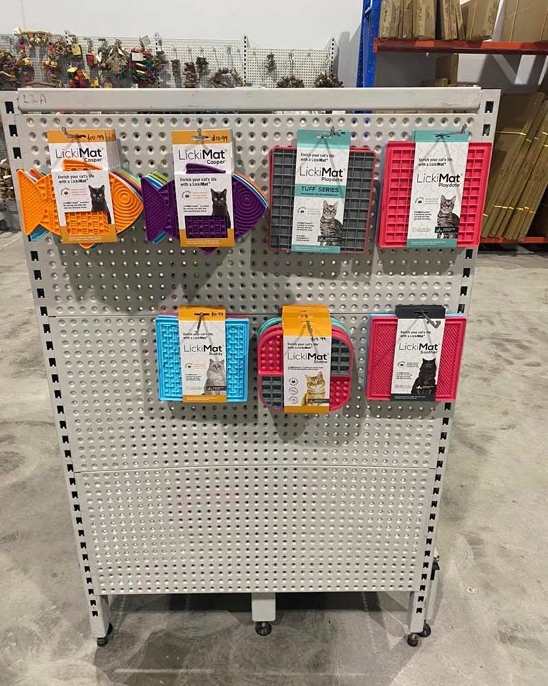 Display Rack With Colourful Cat Lick Mats in a Warehouse Setting — Jonath’s Animal Kingdom in Salamander Bay, NSW