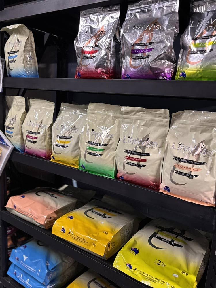 Bags of Dog Food on Black Shelves — Jonath’s Animal Kingdom in Salamander Bay, NSW