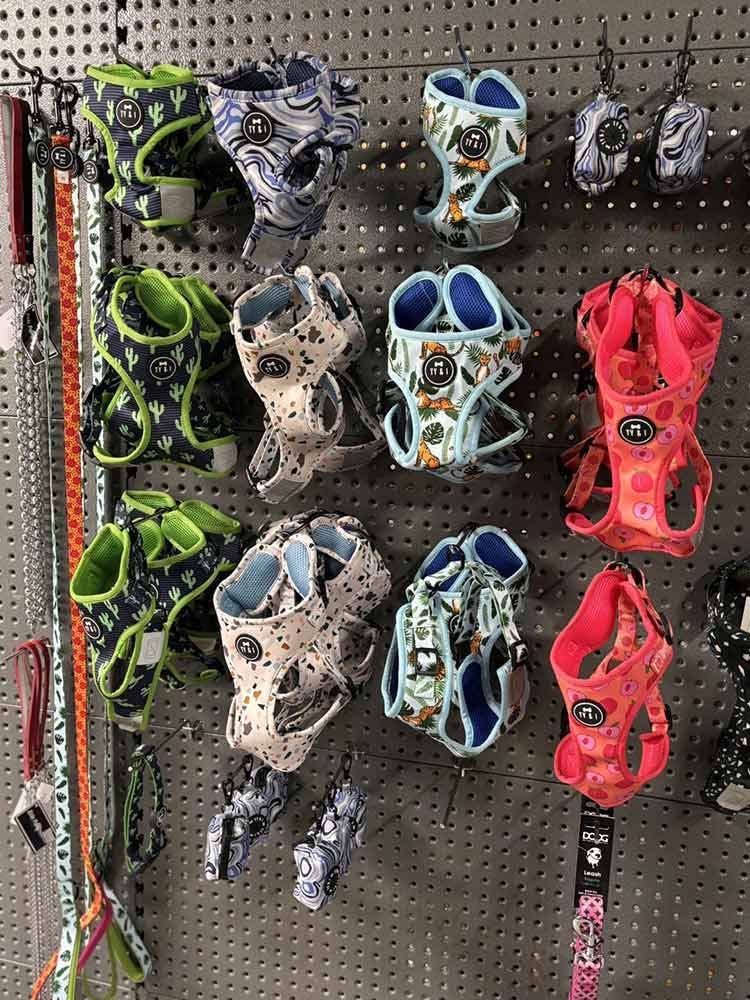 Dog Harnesses on a Pegboard Wall in Various Colours and Patterns — Jonath’s Animal Kingdom in Forster, NSW