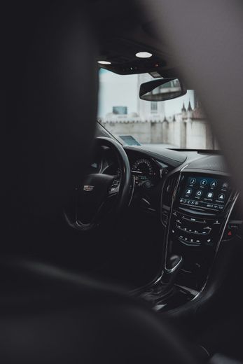 A close up of the interior of a car with a steering wheel and dashboard.