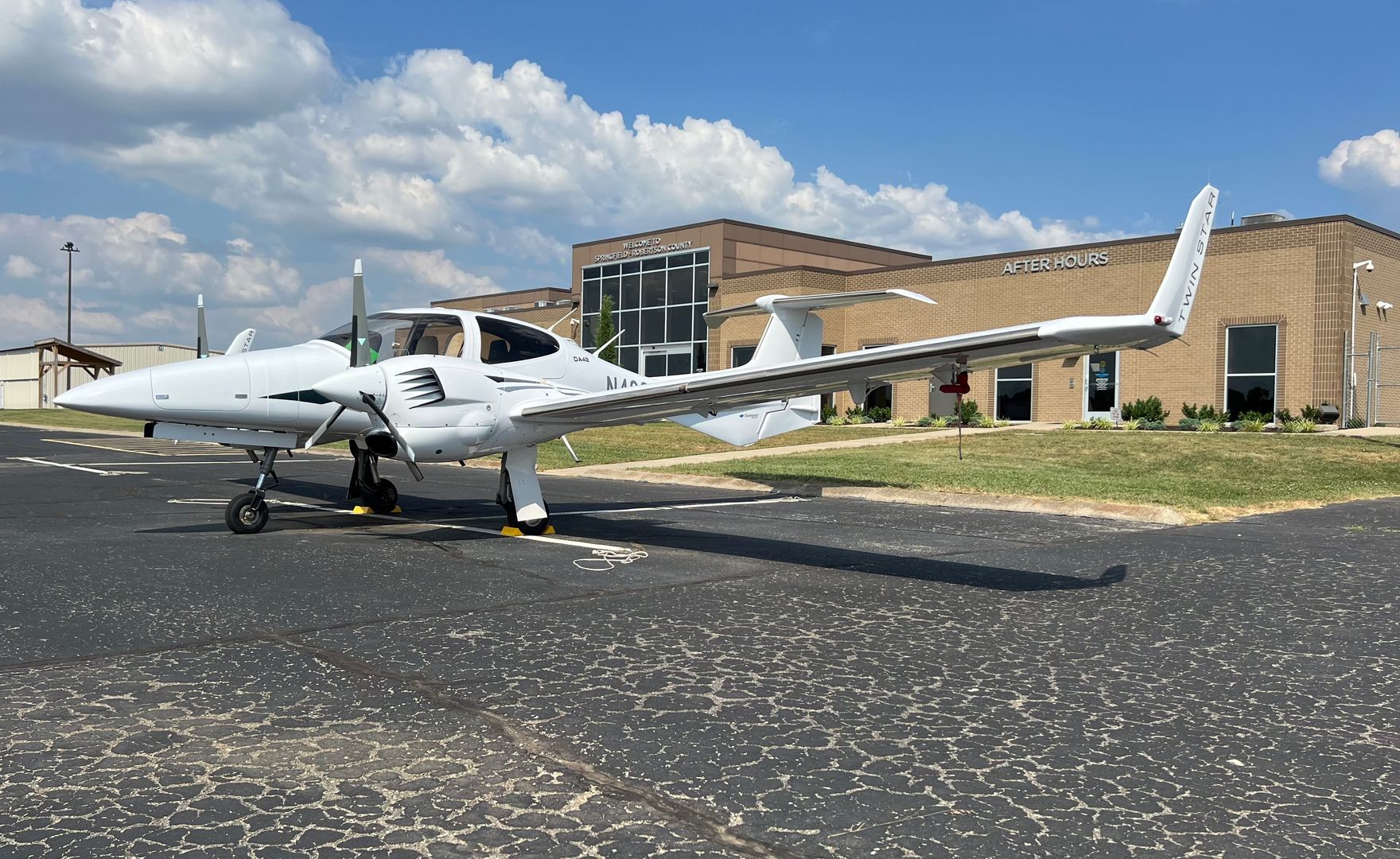 A small propeller plane is parked on a runway.
