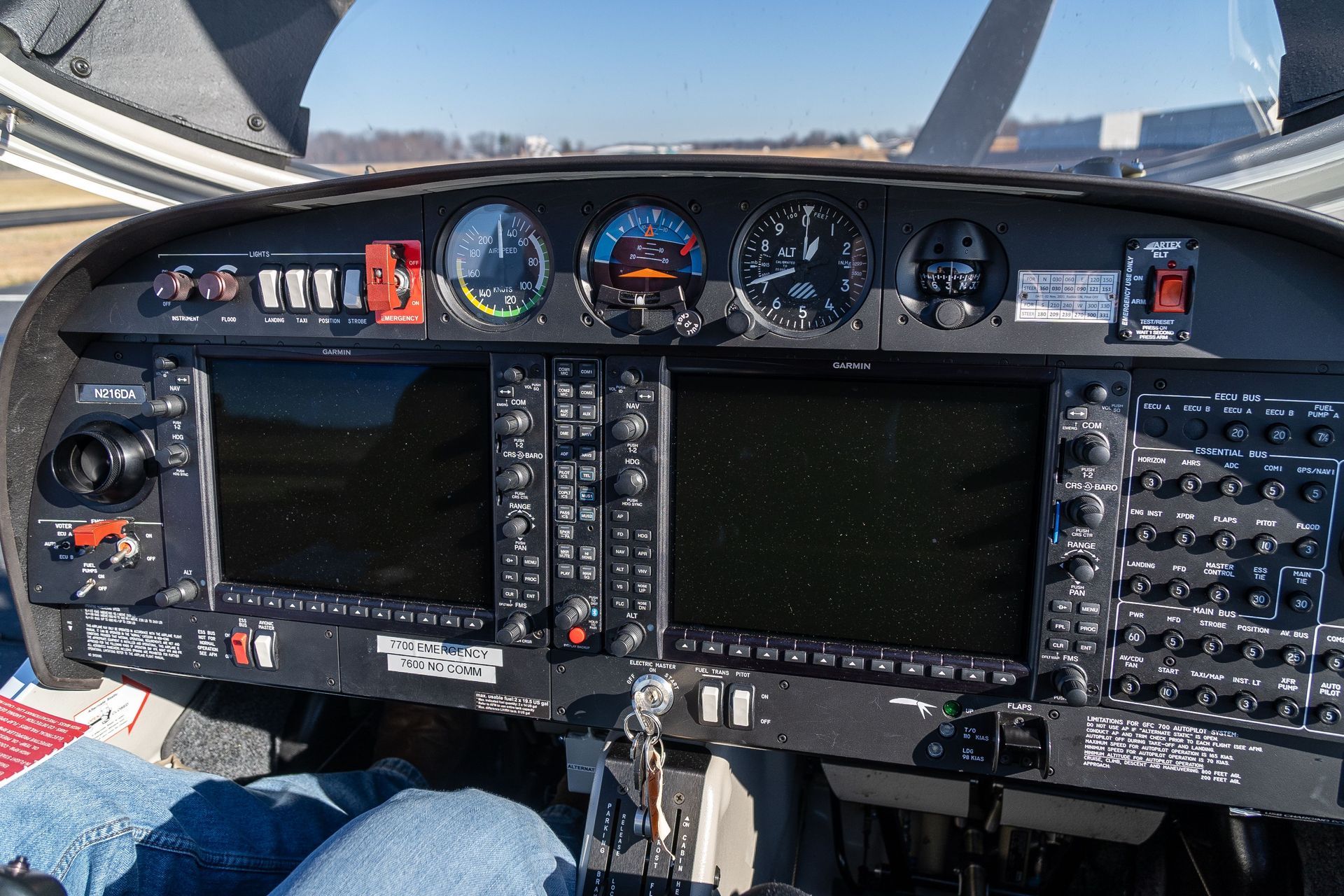 A person is sitting in the cockpit of an airplane.