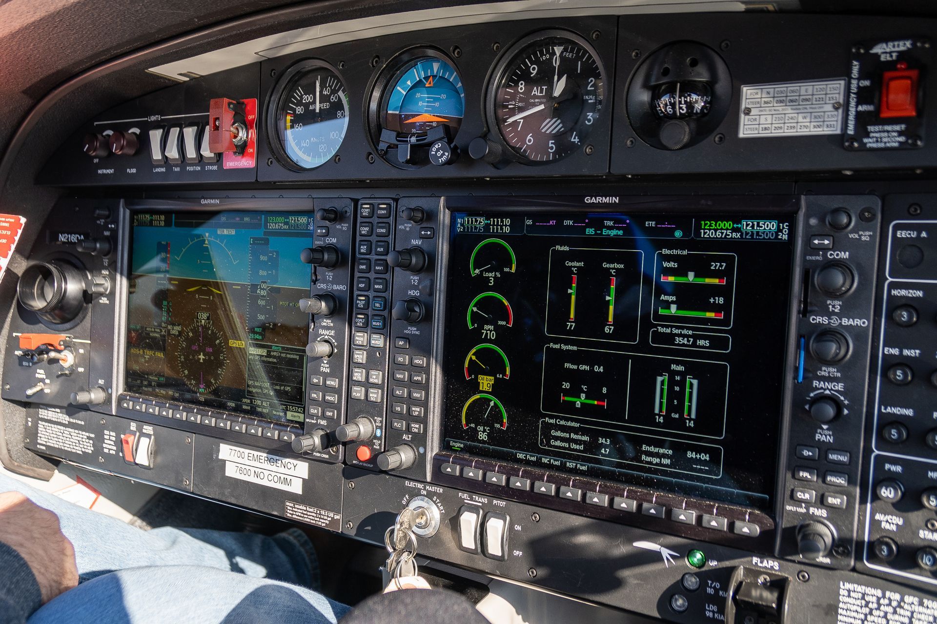 A person is sitting in the cockpit of an airplane.