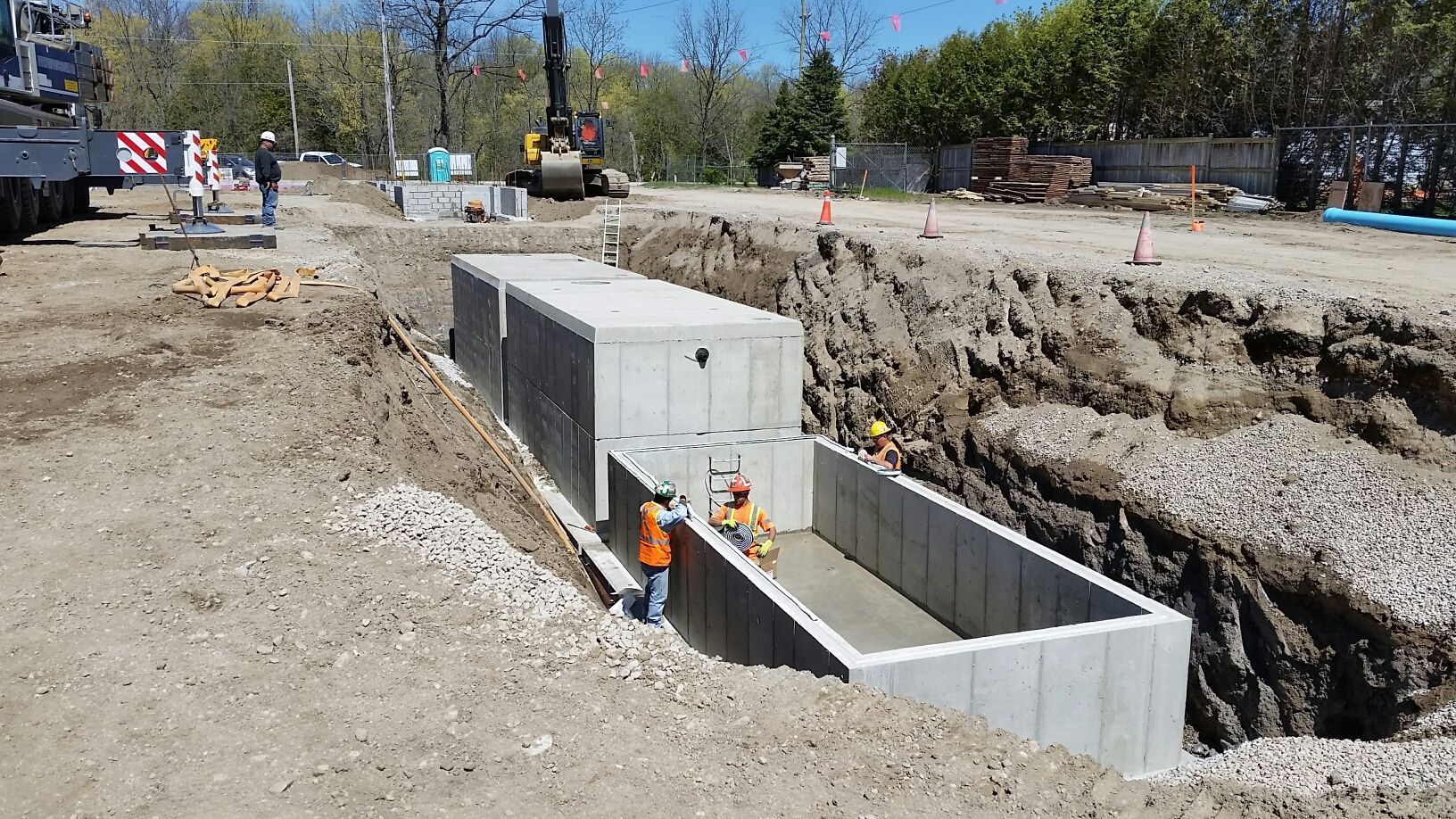 A group of construction workers are working on a large concrete structure.