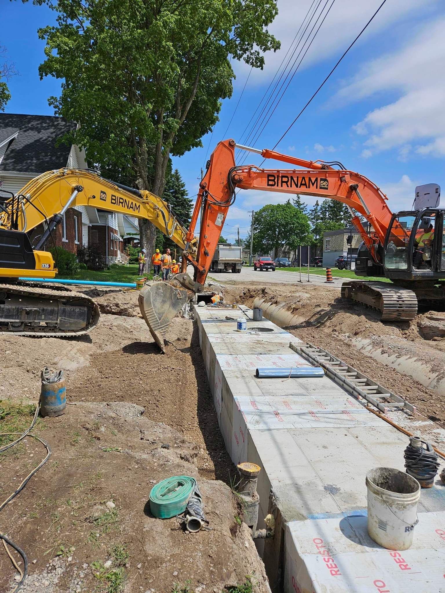 A couple of excavators are working on a construction site.