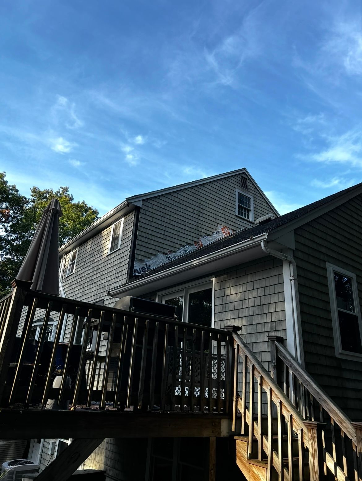 A house with a deck and stairs leading up to it.