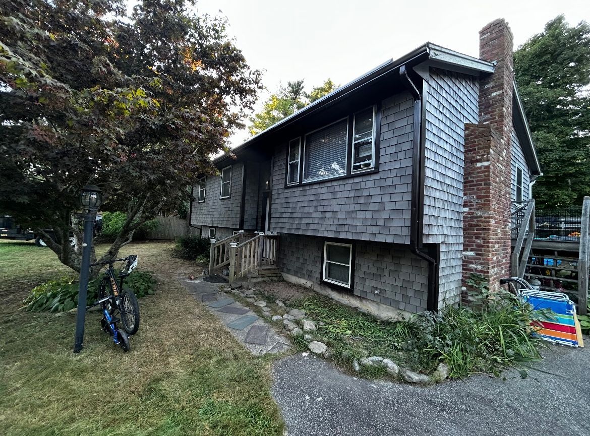 A small house with a bicycle parked in front of it.