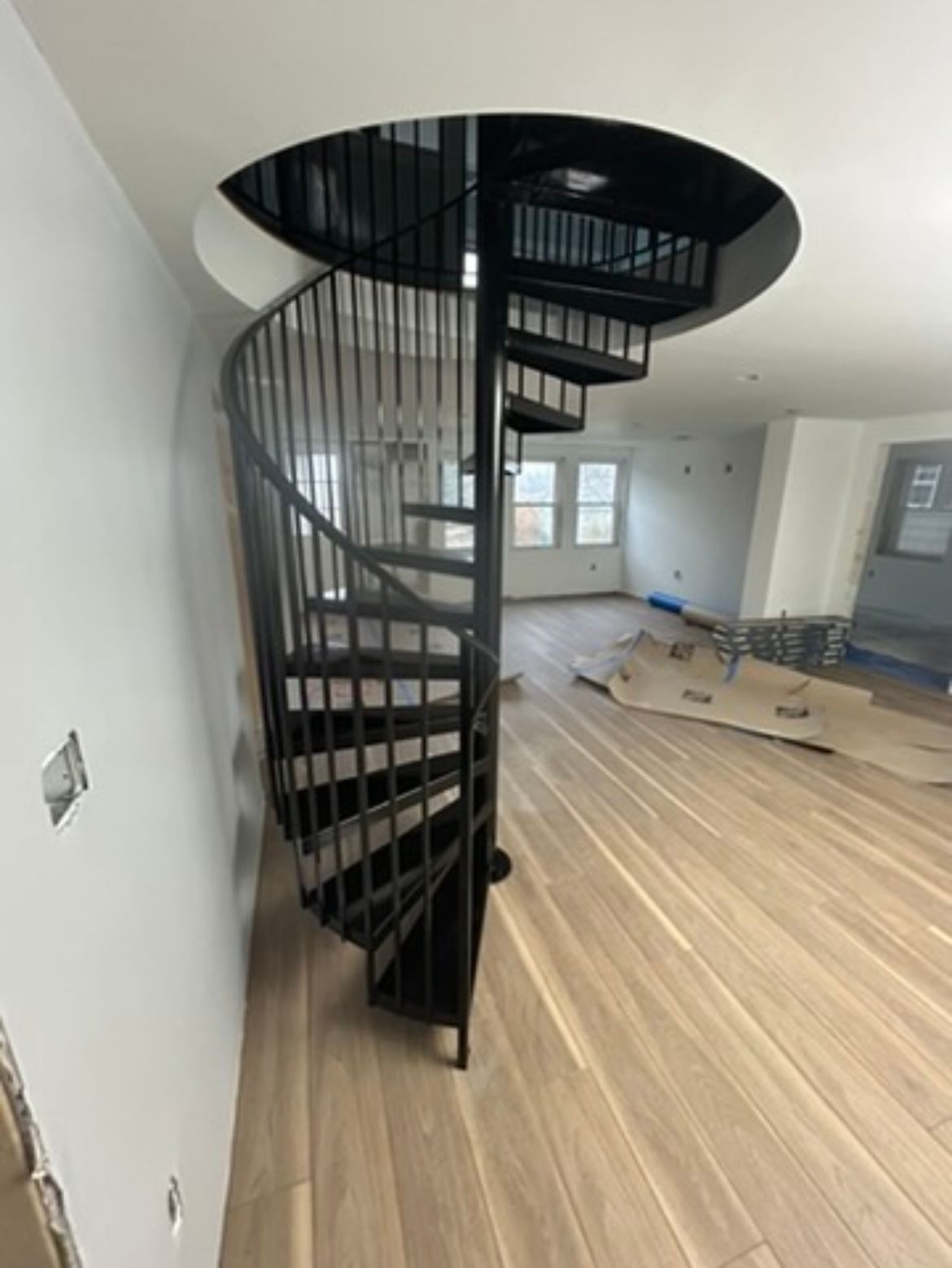 There is a spiral staircase in the middle of the room.