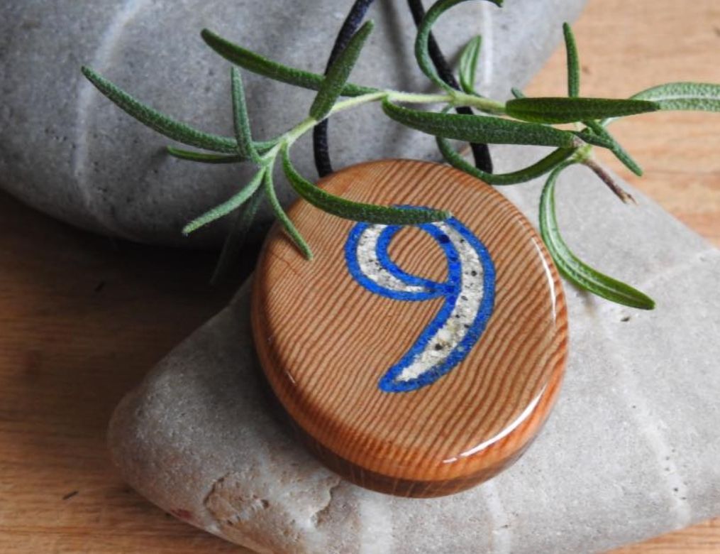 Memorial pendant of old-growth fir and Oak. The number 9 is bordered by lapis lazuli.
