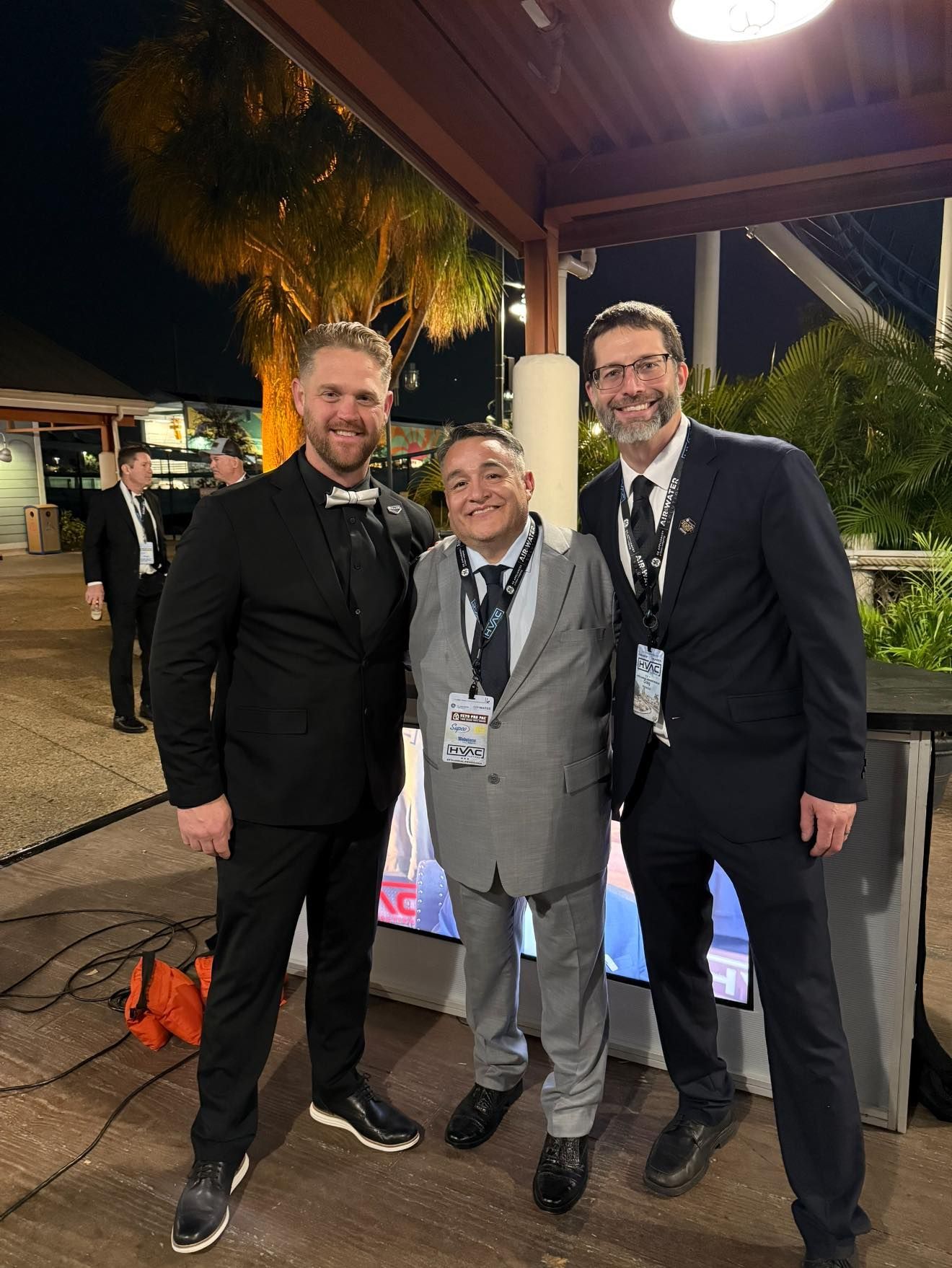 Couple relaxing on a couch, looking at a tablet, smiling. Cozy living room setting.