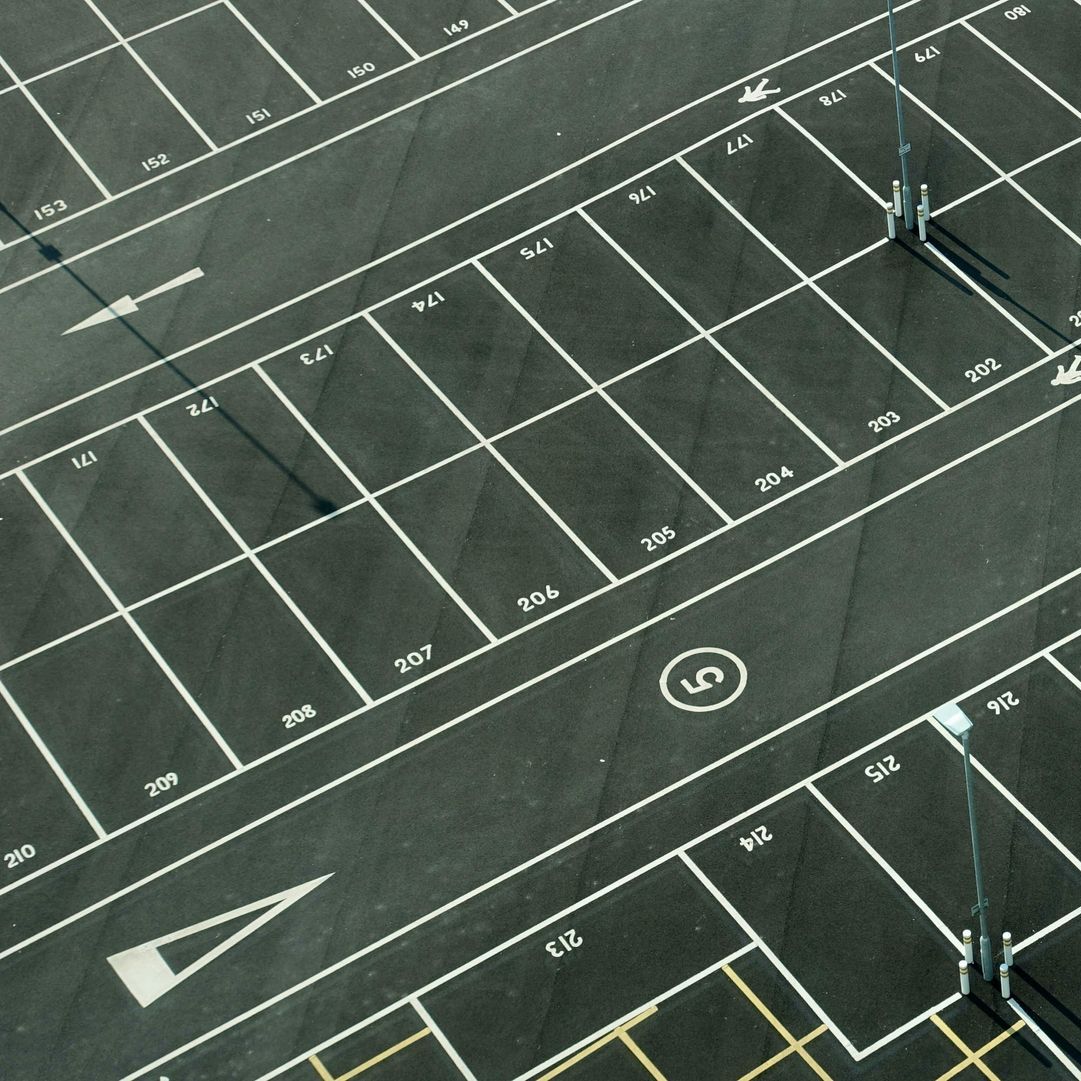 An aerial view of a parking lot with the number 5 in the middle