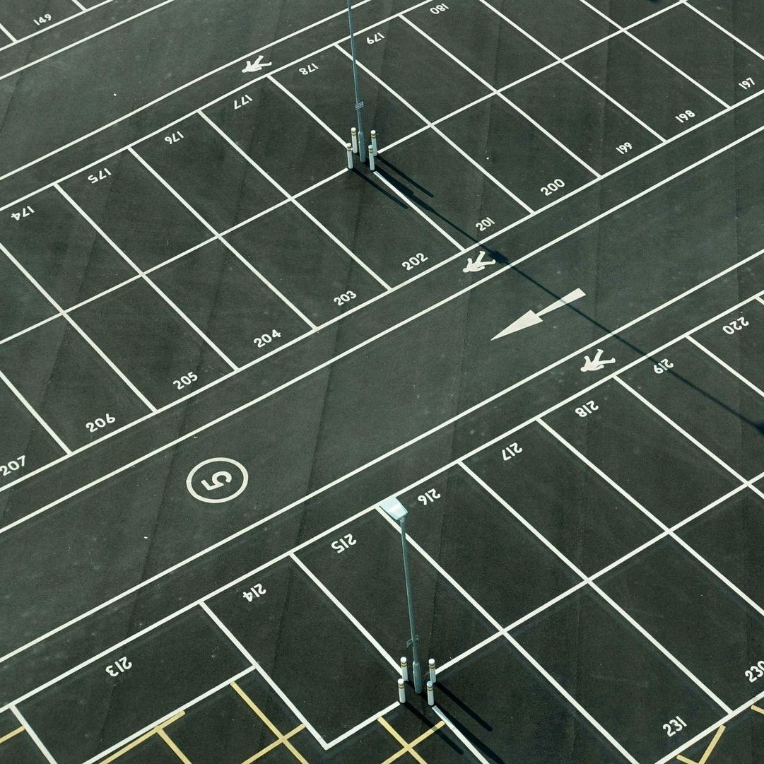 An aerial view of an empty parking lot with the number 5 in the middle