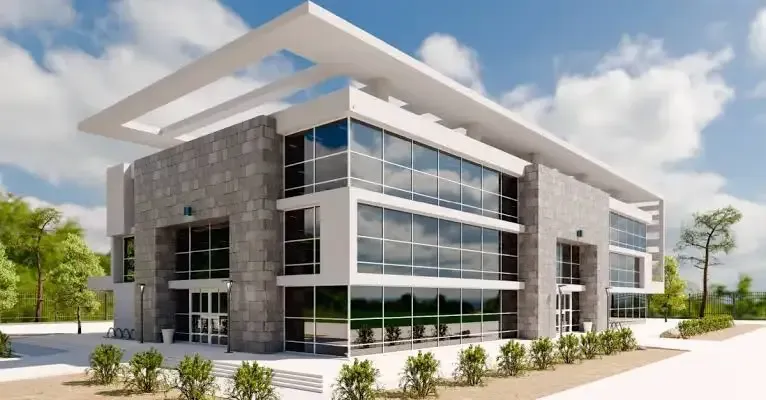 Modern glass-and-stone office building with landscaped grounds under a partly cloudy sky