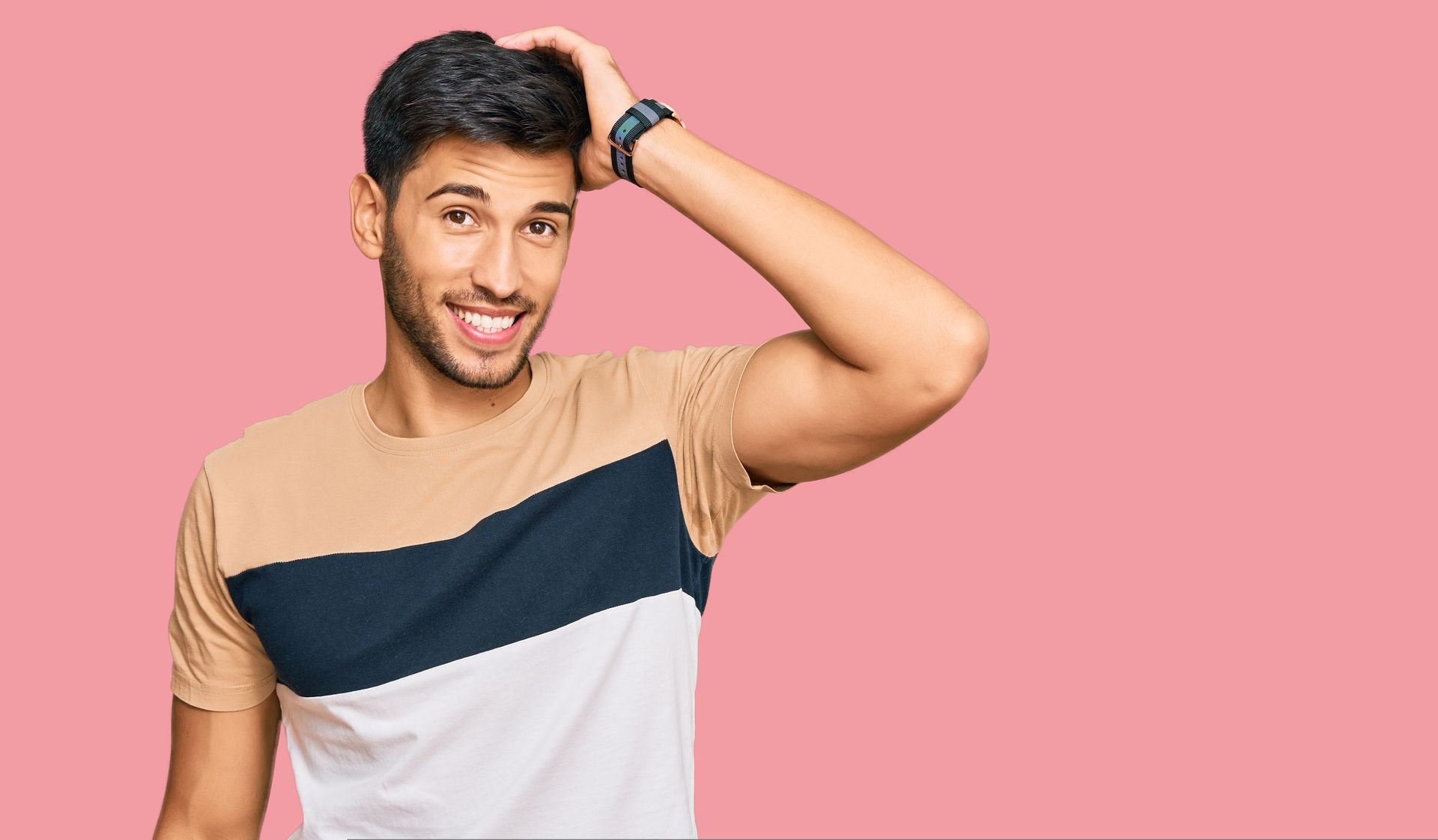 A man is combing his hair with a comb.