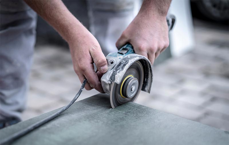 Tiler Cutting Tiles With Grinder