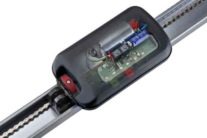 A garage door opener is hanging from the ceiling of a garage.