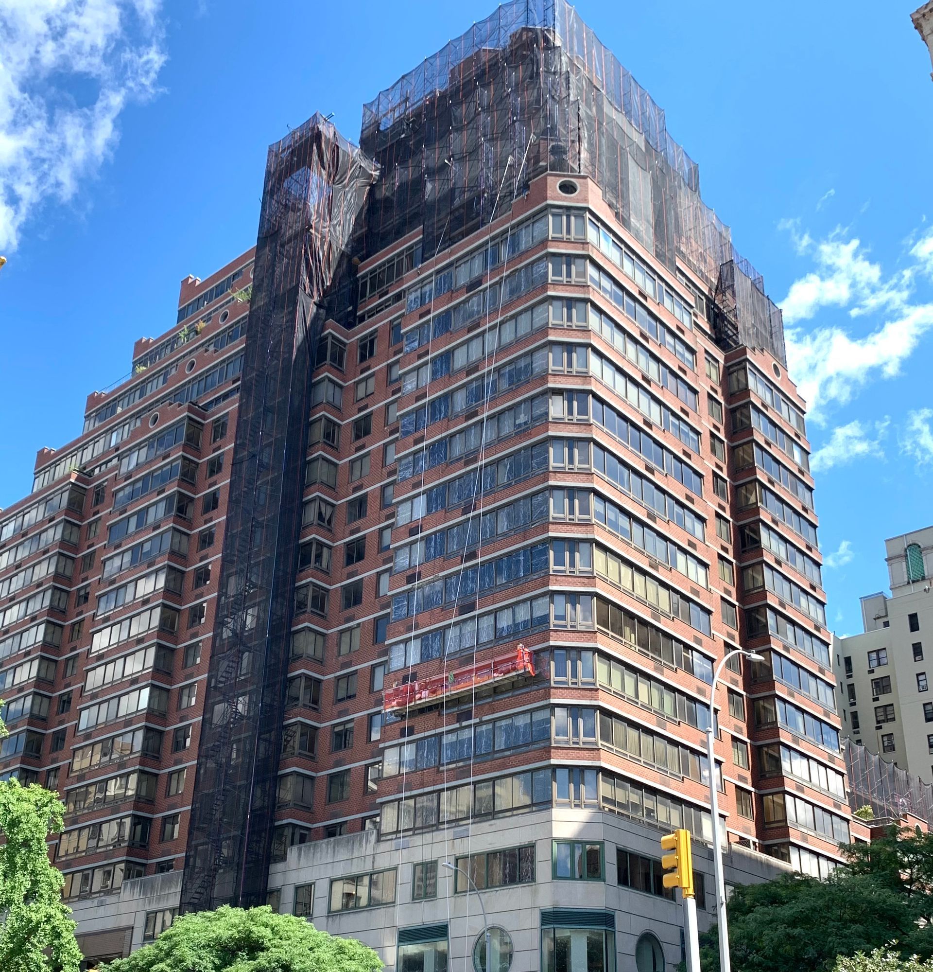 A very tall building with a lot of windows and a blue sky in the background