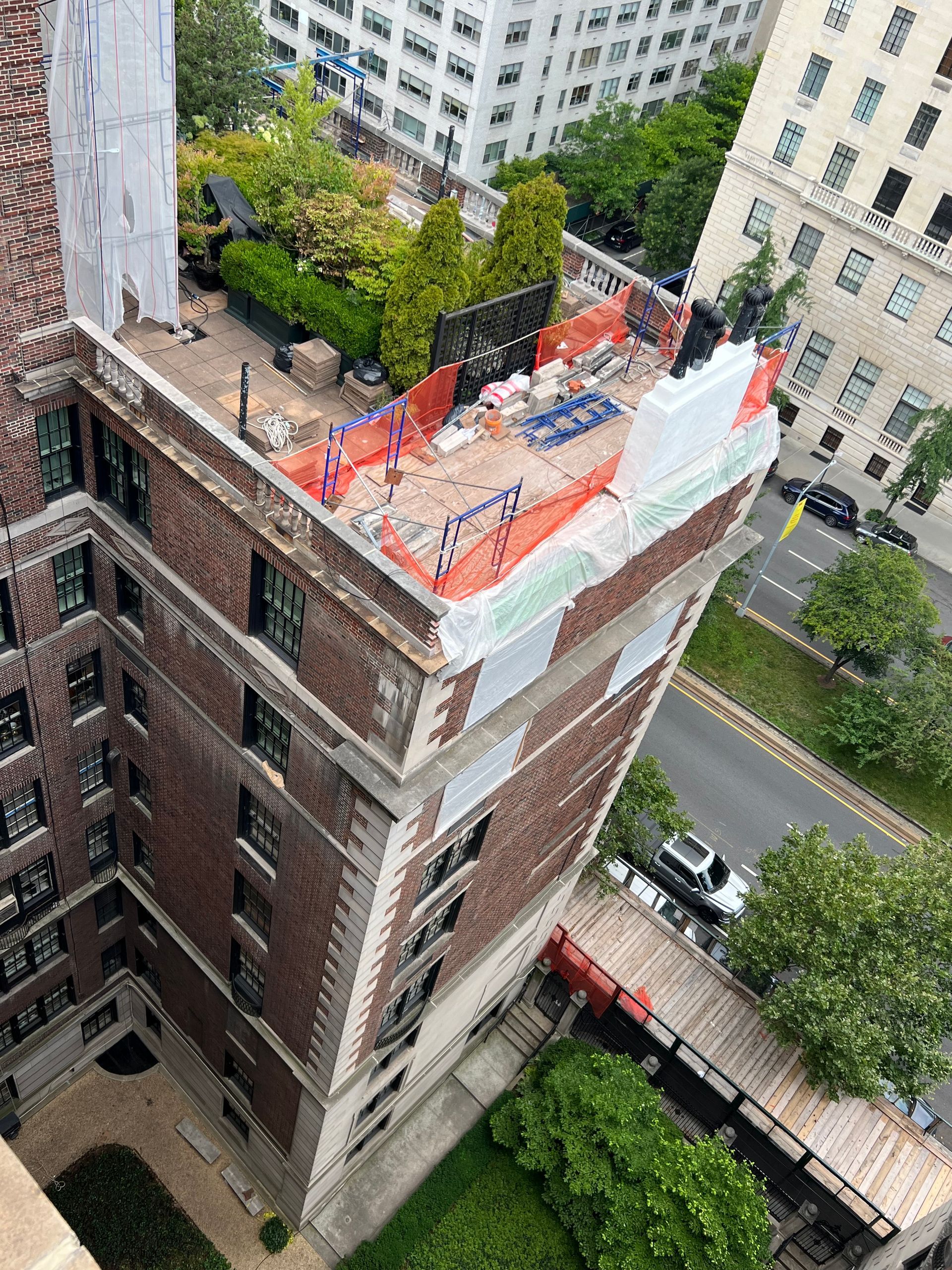 An aerial view of a building under construction with a rooftop garden.